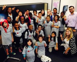 bridges kids with hands raised